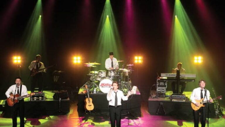 The Hollies se apresentando ao vivo em palco iluminado